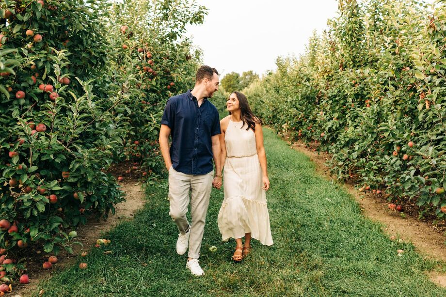 couple-walking-in-apple-orchard